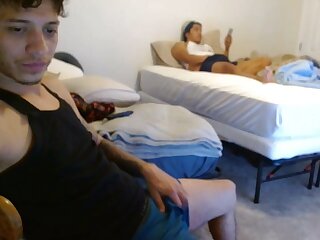 Latin man is flashing with friend in the back