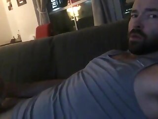 Bearded hairy hunk shoots his massive load all over his chest and beard