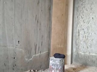 Exhib asian man is getting naked on a construction site