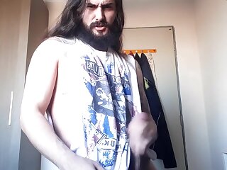 Long haired tatted hunk jerks off his big dick and shoots a load