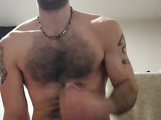 A hot hairy hung plays with his dick and cums